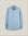 A light blue long-sleeve button-down shirt with a chest pocket, displayed flat against a solid beige background.  Made in USA OCBD shirt.  