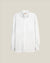 A white long-sleeve button-down shirt with a single chest pocket, displayed flat against a solid light beige background.  Made in USA White OCBD