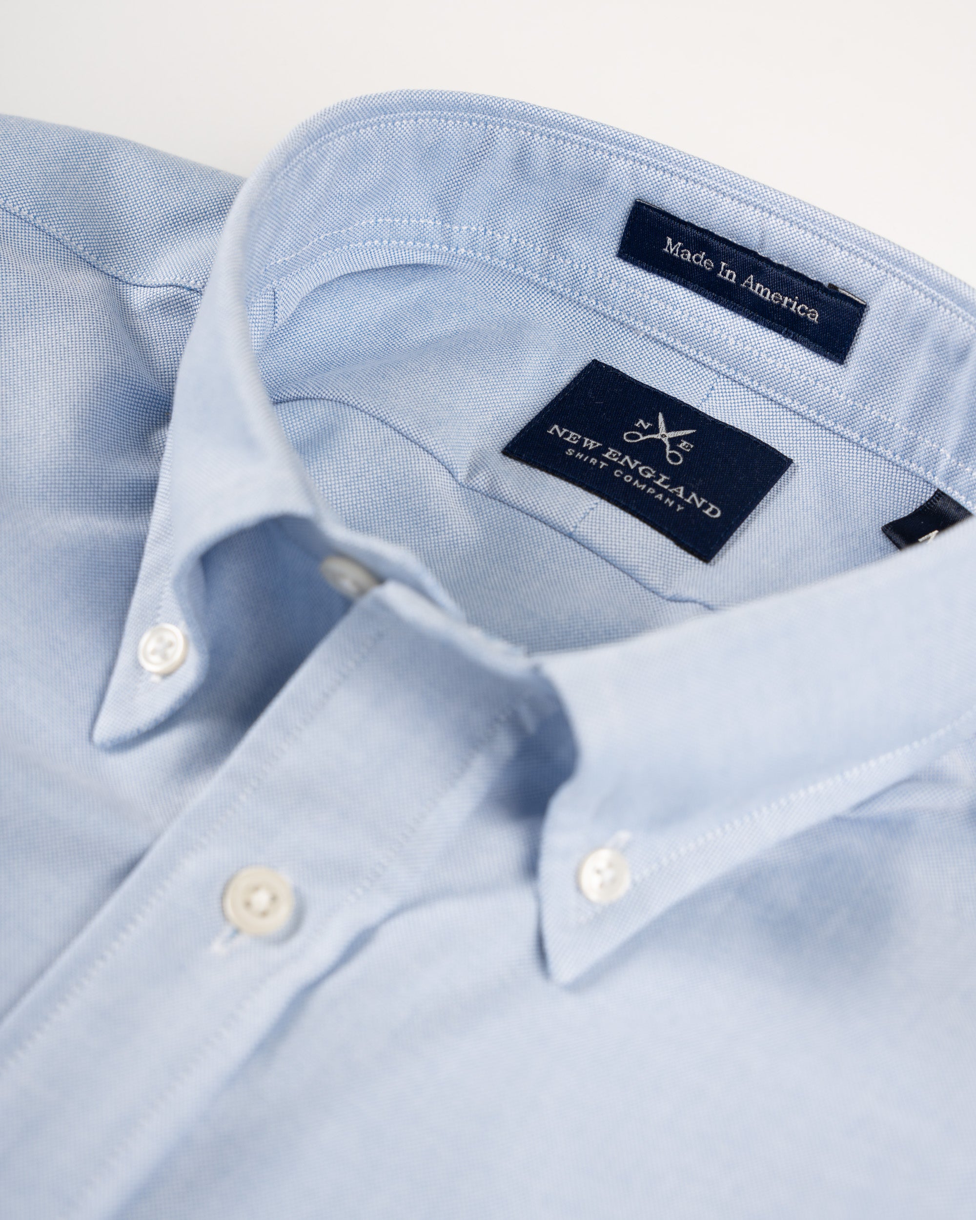 Light blue bristol oxford button-down shirt with New England Shirt Co label on a white background